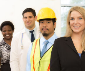 Workforce showing professional business women, construction worker, and doctor in an office building.